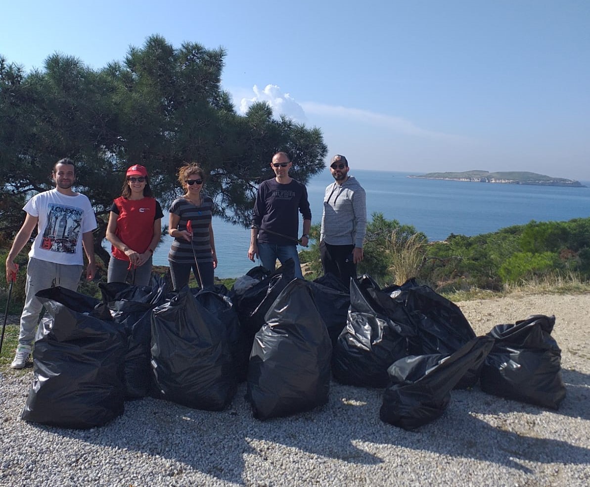 Gonul and team helping clean up a local beach