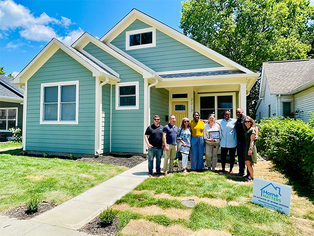 employees in front of restored house