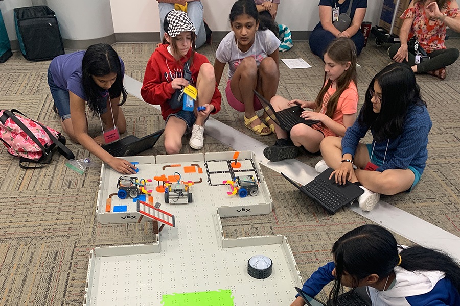 Kids tinkering with VexGo Robotic Competition Field