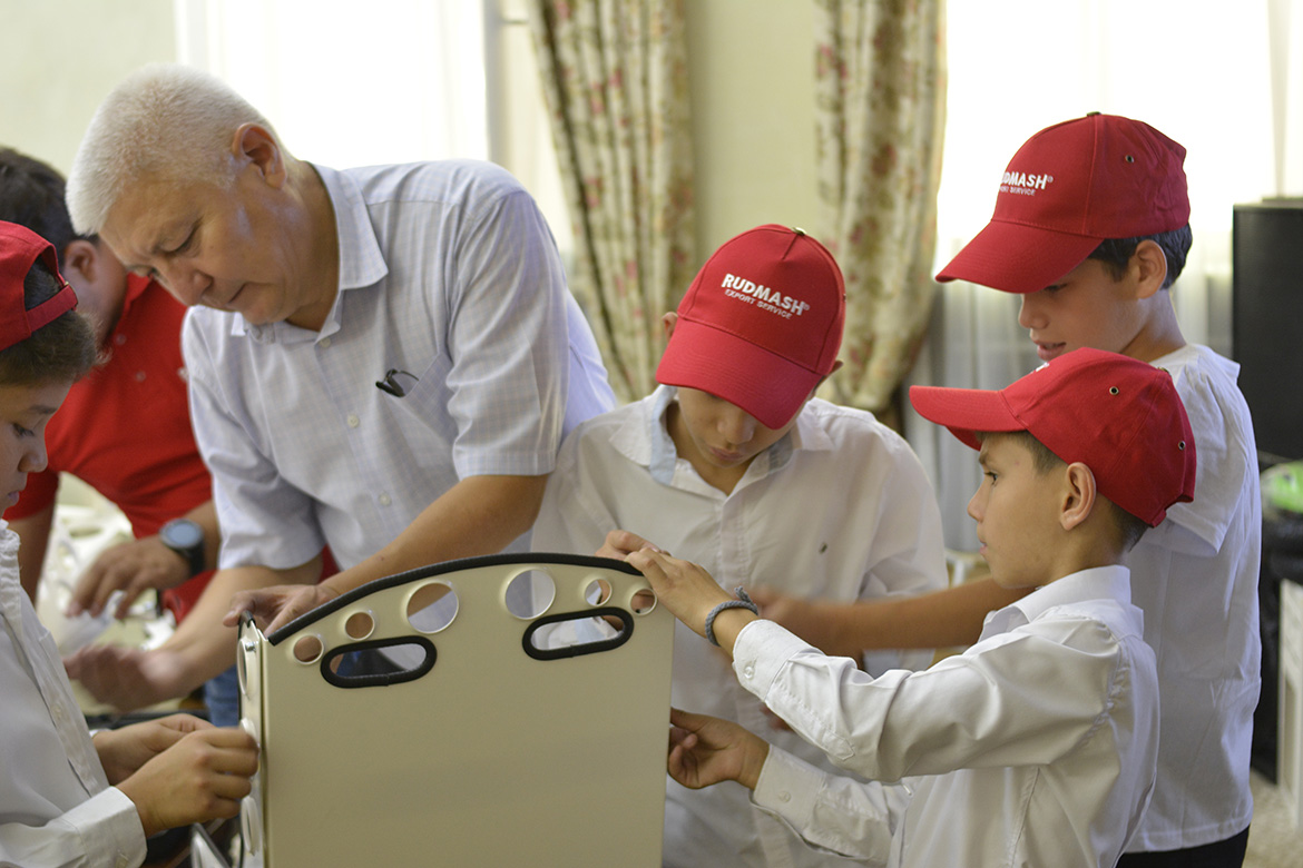 Students at the Children's Home working on the car